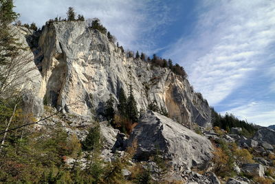 Low angle view of rocks on mountain against sky