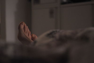 Barefoot of person on bed