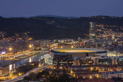 High angle view of illuminated city buildings at night