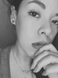 Close-up portrait of young woman at home