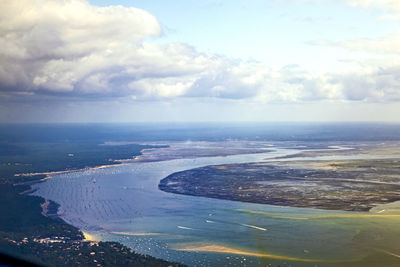 Aerial view of sea and landscape against sky