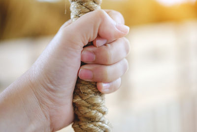 Close-up of mother holding baby hand