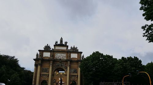 Low angle view of building against cloudy sky