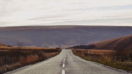 Road amidst landscape against sky