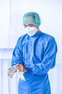 Doctor wearing mask against white background