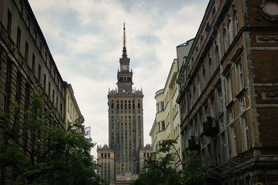 Low angle view of buildings against cloudy sky