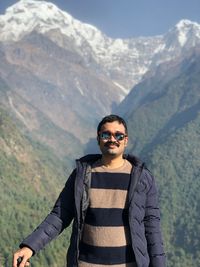Portrait of man standing against mountain