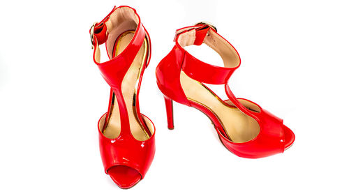 Close-up of red shoes over white background