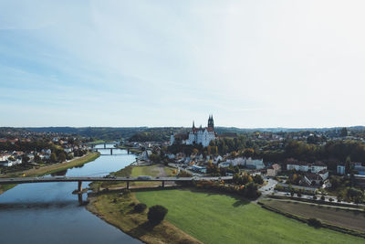 High angle view of river by buildings against sky
