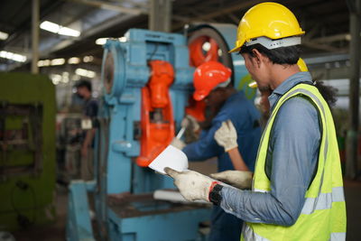 Portrait of male worker standing in the heavy industry manufacturing factory.