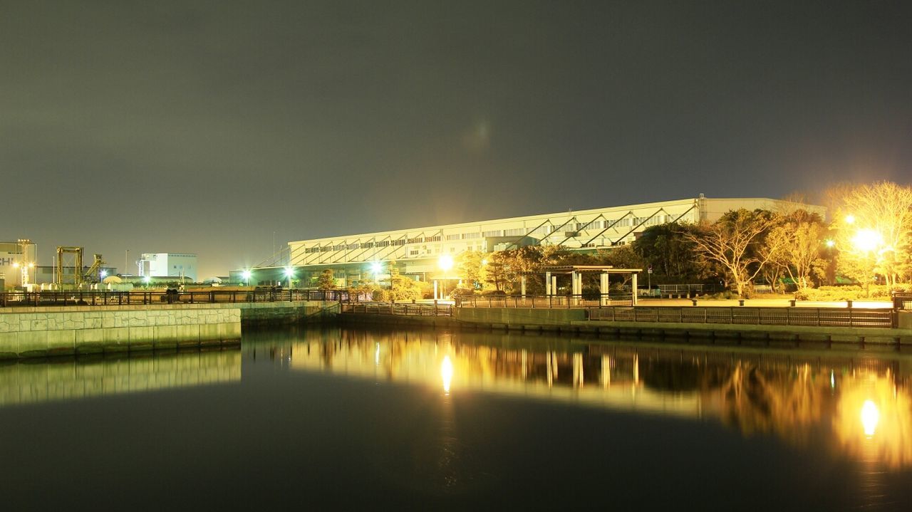 illuminated, architecture, night, built structure, reflection, building exterior, water, waterfront, river, clear sky, city, copy space, bridge - man made structure, connection, sky, no people, outdoors, glowing, light - natural phenomenon, building