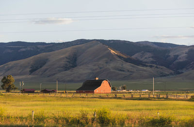 Scenic view of field and mountains against sky