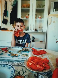 Portrait of smiling girl with food on table