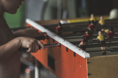 Close-up of boy playing foosball