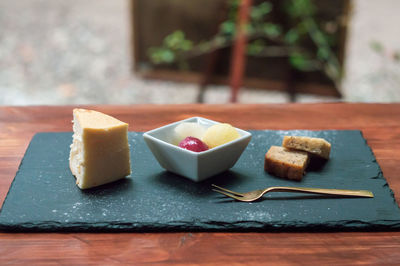 Close-up of cake and fruits on table