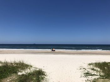 Scenic view of sea against clear blue sky
