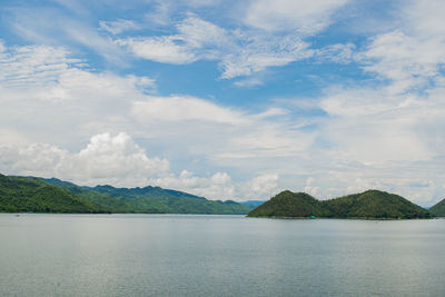 Scenic view of sea and mountains against sky