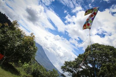 Low angle view of flags against sky