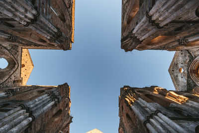 Directly below shot of old buildings against clear sky