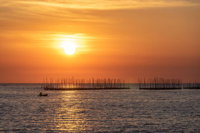 Oyster farm in the sea and beautiful sky sunset background , sun and cloud landscape nature thailand