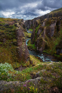 Scenic view of waterfall against sky