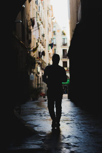 Full length rear view of man standing in city