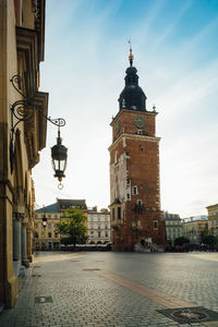 View of clock tower amidst buildings in city