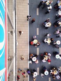 Directly above shot of people at sidewalk cafe in city