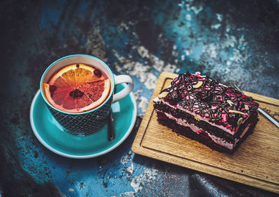 High angle view of tea and cake on table