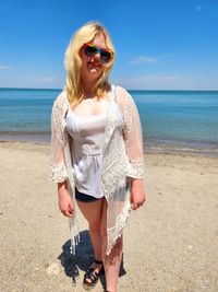Young woman standing at beach