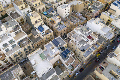 Malta, northern region, mellieha, aerial view of solar panels on rooftops of city houses
