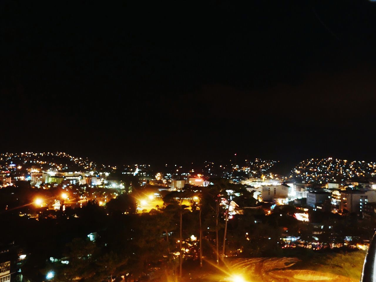 illuminated, night, cityscape, city, building exterior, architecture, built structure, crowded, copy space, dark, glowing, high angle view, sky, residential district, light, light - natural phenomenon, clear sky, residential building, city life, lighting equipment