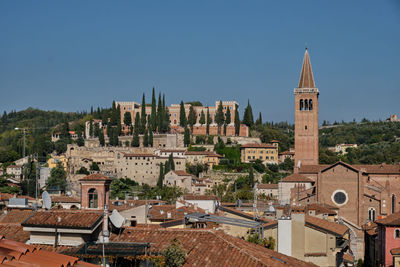 Buildings in city against clear sky