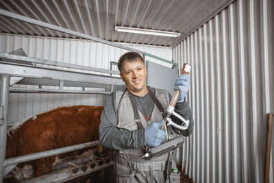 Portrait of young man standing in factory