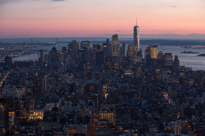 Aerial view of a city lit up at sunset