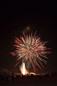 Low angle view of firework display at night