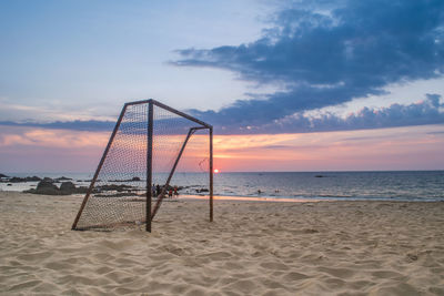 Scenic view of beach against sky during sunset