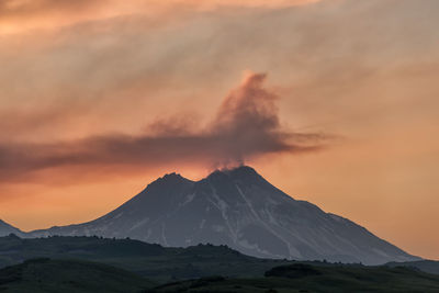 Scenic view of snowcapped mountains against sky during sunset