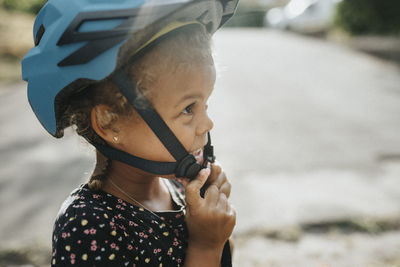 Close-up of girl wearing bicycle helmet
