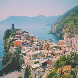 High angle view of houses by sea against sky