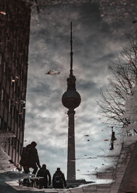 People on street amidst buildings in city