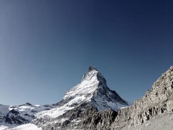 Scenic view of rocky mountains against sky on sunny day