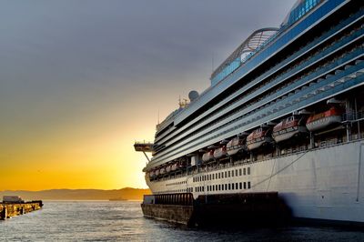 View of ship in sea at sunset