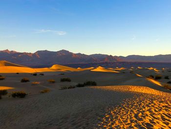 Scenic view of desert against sky during sunset