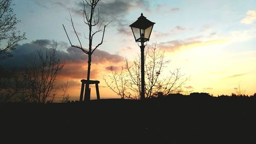 Silhouette street light against sky during sunset