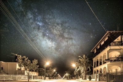 Low angle view of illuminated buildings against sky at night