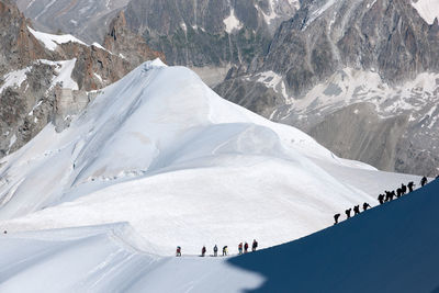 Aerial view of people on snow covered mountain