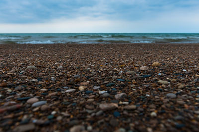 Scenic view of beach against cloudy sky