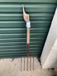 High angle view of metal on wood against wall