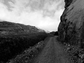 Road amidst mountains against sky